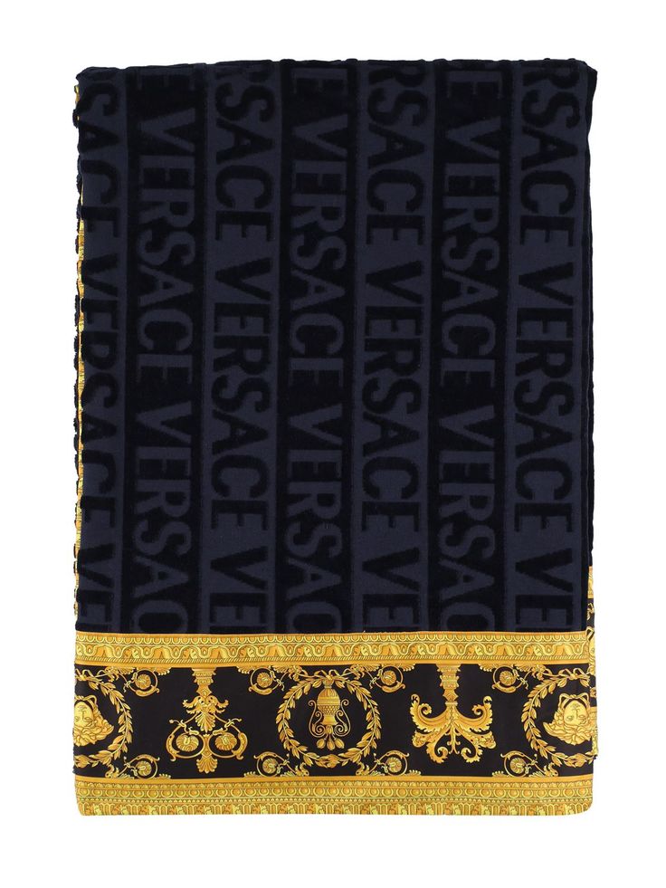 a black and gold scarf with the words versa versa on it's side, in front of a white background