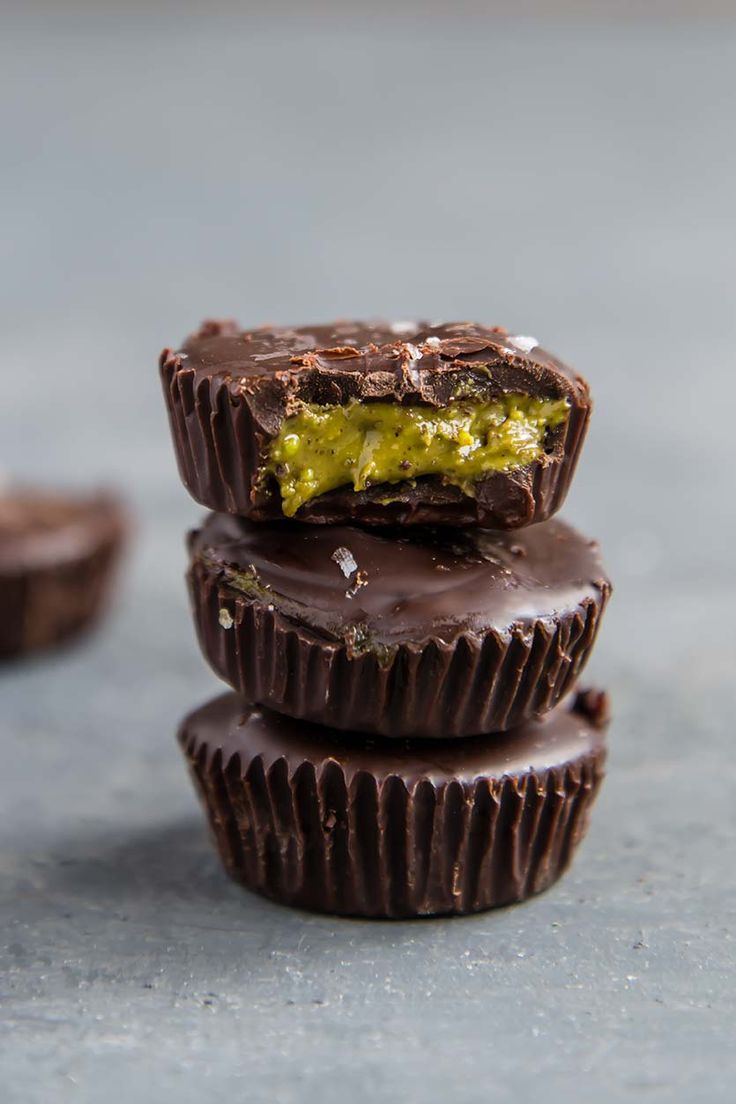 three chocolates stacked on top of each other with one bite taken out of it