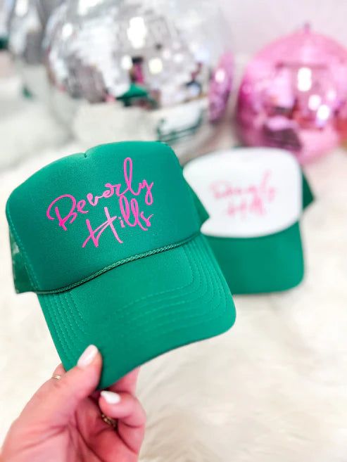 Top off your look with this stylish, Beverly Hills-approved trucker hat! The bright green color features a bright splash of pink lettering - guaranteed to turn heads. Perfect for a day outdoors, this hat is the ultimate accessory for a mood to match the sunny weather! Green Baseball Cap With Curved Bill For Summer, Green Curved Bill Baseball Cap For Summer, Trendy Pink Trucker Hat With Curved Visor, Casual Green Trucker Hat With Letter Print, Trendy Green Baseball Cap For Outdoor, Summer Green Trucker Hat With Letter Print, Green Trucker Hat With Letter Print For Summer, Green Summer Trucker Hat With Letter Print, Fun Green Trucker Hat For Summer