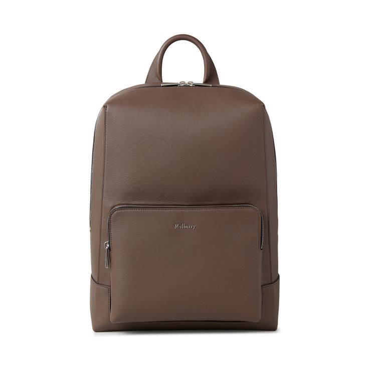 The Farringdon Backpack is characterised by its clean, minimal design and masculine feel. Crafted from luxurious leather and finished with metallic Mulberry branding, it has plenty of space for essentials, making it the perfect partner for modern tailored wardrobes. Brushed Silver hardware finish Mulberry metal lettering Adjustable padded shoulder straps One top handle Padded laptop sleeve Zipped closure External zipped pocket Padded back 11½"W x 15¼"H x 6¼"D Modern Business Backpack With Leather Backing, Modern Leather Backpack With Smooth Grain, Modern Brown Backpack For Business Trips, Modern Business Backpack With Leather Lining, Modern Travel Backpack With Smooth Grain, Modern Leather Backpack For Office, Modern Smooth Grain Leather Rectangular Backpack, Luxury Rectangular Smooth Grain Backpack, Luxury Smooth Grain Leather Backpack For Business