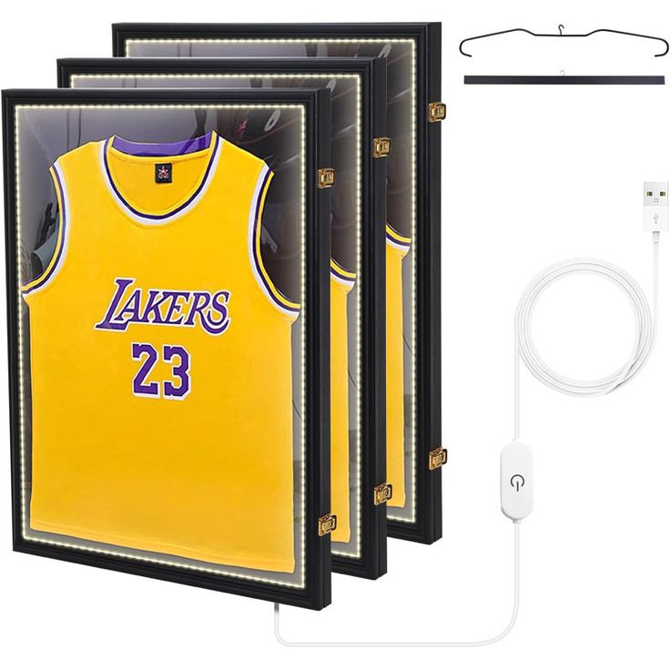 the lakers jersey is hanging in front of an ipod charger and earbuds