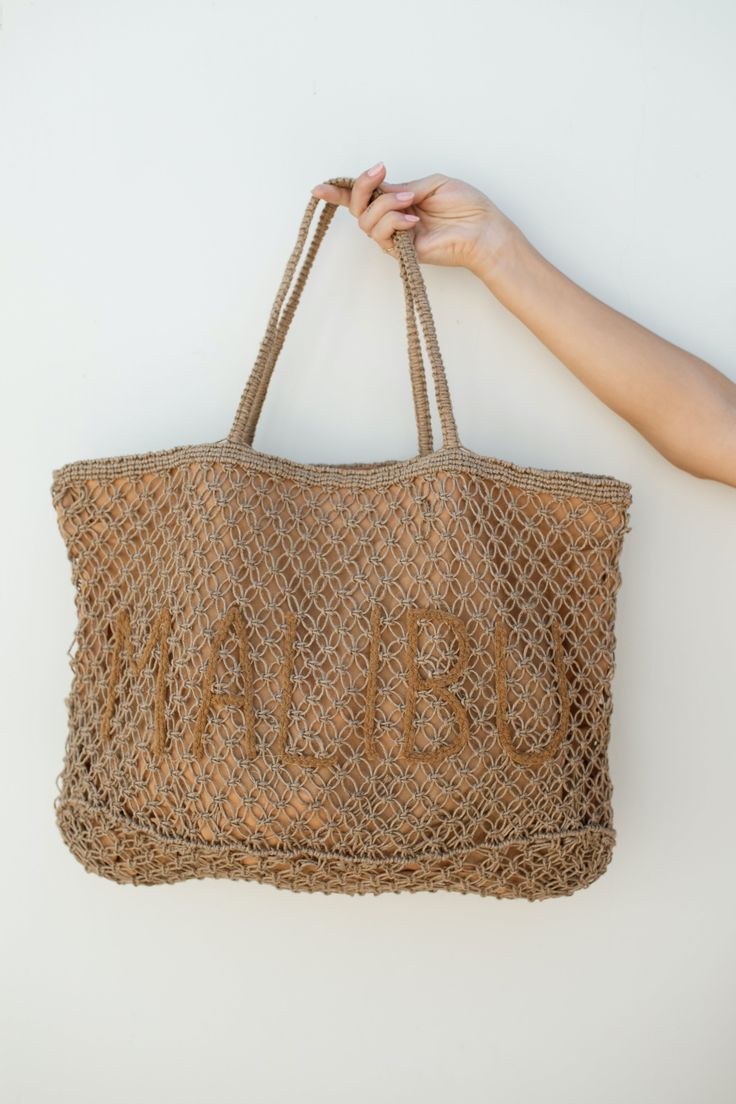 Pack your beach essentials in this stylish Malibu Tote! Crafted from woven jute, it features an inner zipper pocket to stash your keys and cell phone with ease. Plus, its beachy tones give the perfect coastal touch to any summer outfit. DETAILS 20" Long, 13" Wide Handles: 9" Zipper Pocket Inside Beachy Beach Bag With Open Weave For Travel, Summer Beach Bag With Pockets For Everyday, Casual Everyday Straw Bag In Sand Color, Beige Lightweight Beach Bag, Natural Cotton Beach Bag, Lightweight Beige Beach Bag, Beachy Open Weave Beach Bag For Travel, Casual Open Weave Beach Bag For Travel, Casual Natural Beach Bag