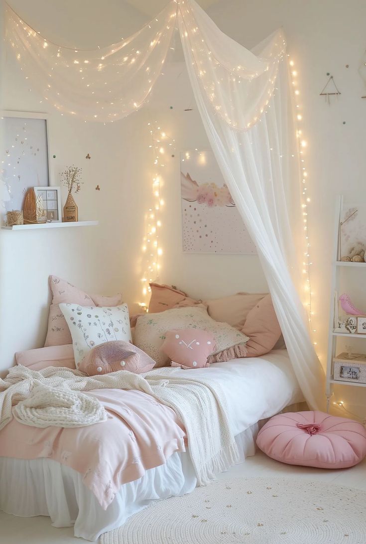 a white bed with pink pillows and lights on the headboard, in a girls'bedroom