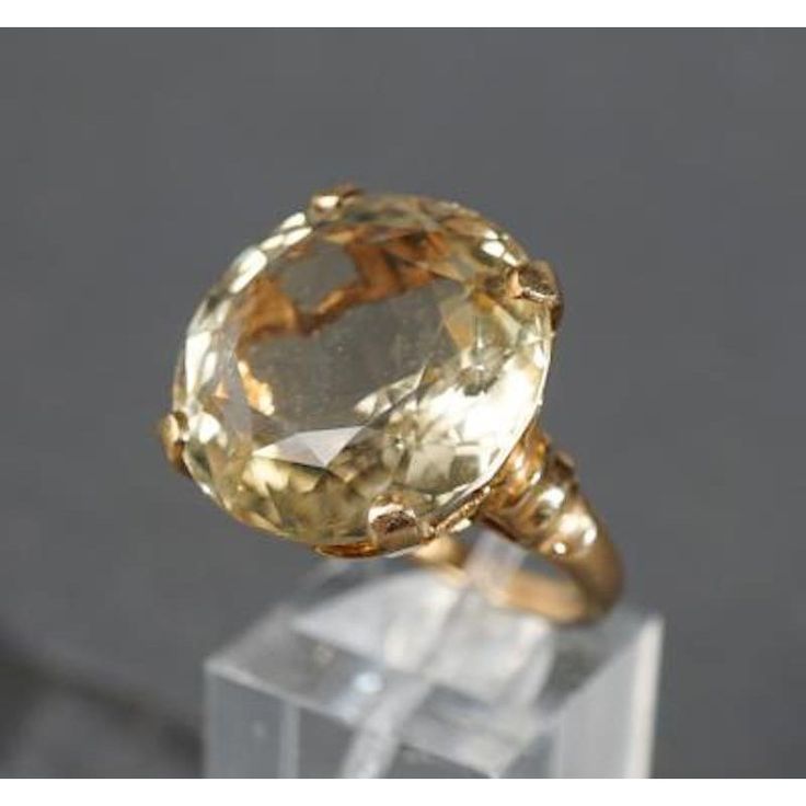 This is part of Chairish’s Fine Jewelry assortment.  Stylish Round Yellow Topaz, Vintage 14k Yellow Gold Large Cocktail Ring. Ring size 6.5 in. Stone: 19.5 mm x 19.6 mm x 10.2 mm Weight of Ring: 9.6 grams The Round cut Yellow Topaz is a large stone, estimated at 23 carats, securely set into a high rising mount that is designed to show the beauty of the gemstone.  If you would like more information, please contact me via email, mrboult@gmail.com. Yellow Topaz Engagement Ring, Topaz Engagement Ring Yellow, Yellow Topaz Ring, Champagne Diamond Ring, Champagne Diamond Rings, Yellow Gems, Vintage Jewellery Rings, Gold Outfit, Large Stone