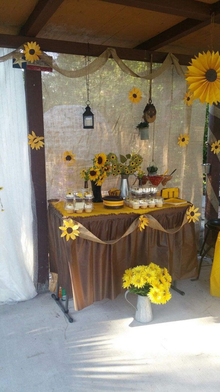 a table with sunflowers and other decorations on it