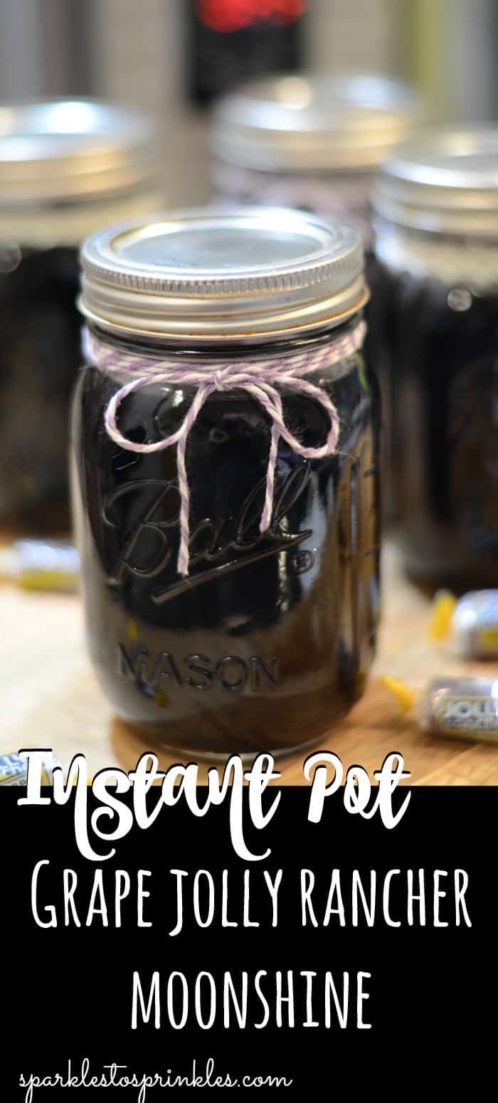 mason jar filled with grape jolly rancher moonshine sitting on top of a table