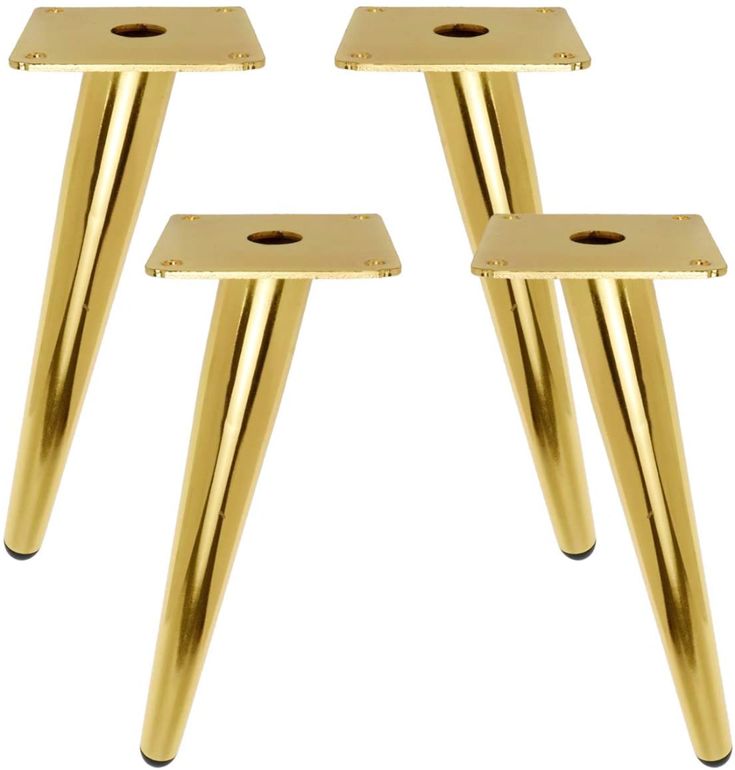 three gold metal legs with holes in the middle