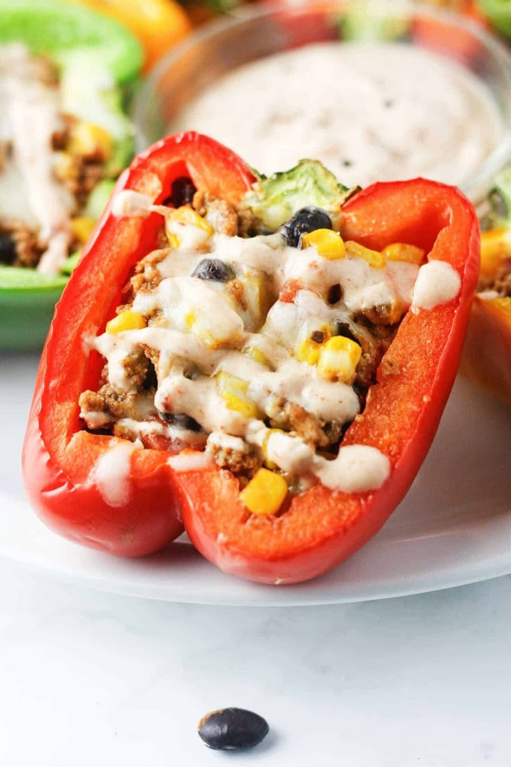 stuffed bell peppers on a plate with ranch dressing