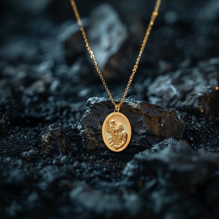 Elevate your faith and protection with our gold St Christopher pendant. This solid gold necklace showcases exquisite craftsmanship, symbolizing the patron Saint of travelers and Catholic devotion. More than just jewelry; it's a fine representation of faith and safeguarding. PENDANT INFORMATIONThis pendant is made of real, solid gold.• Made in USA• Material: 14k or 18k solid gold• Finish: polished• Height: 1.25" (31,5 mm) | *includes the small circle, bail dimensions not included• Width: 0.84" (2