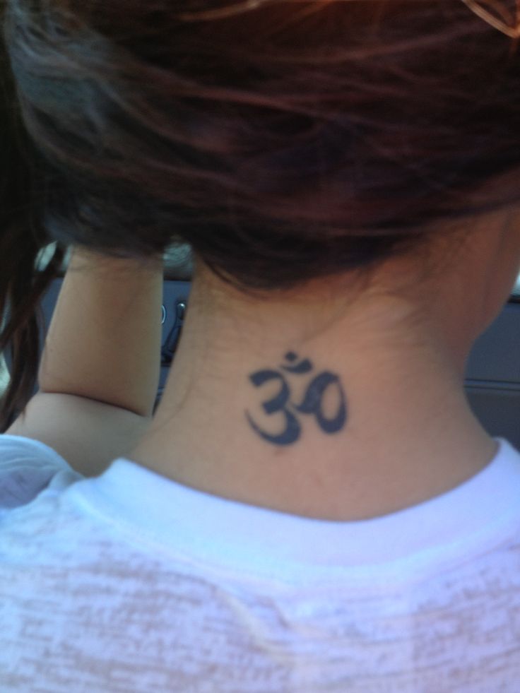 a woman with a tattoo on her neck that has an omen symbol on it