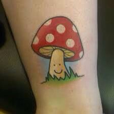 a mushroom tattoo on the leg of a woman