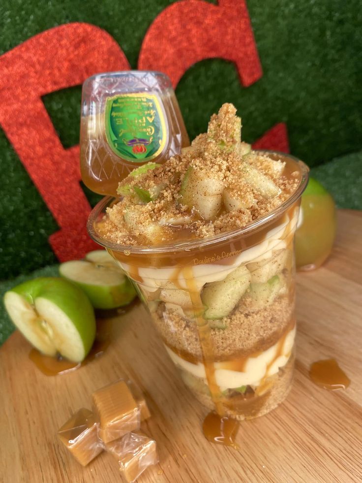 an apple dessert in a plastic cup on a table