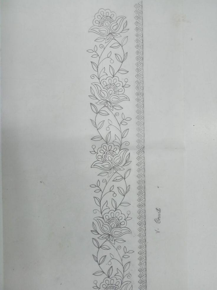 a line drawing with flowers and leaves on it, next to a piece of paper