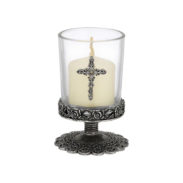 a glass candle holder with a cross on it