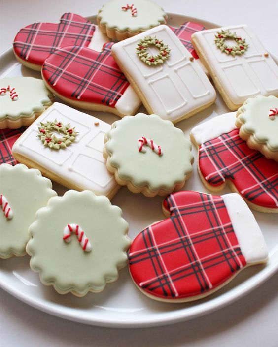 decorated cookies are arranged on a plate with red and white plaid designs, including one for the door