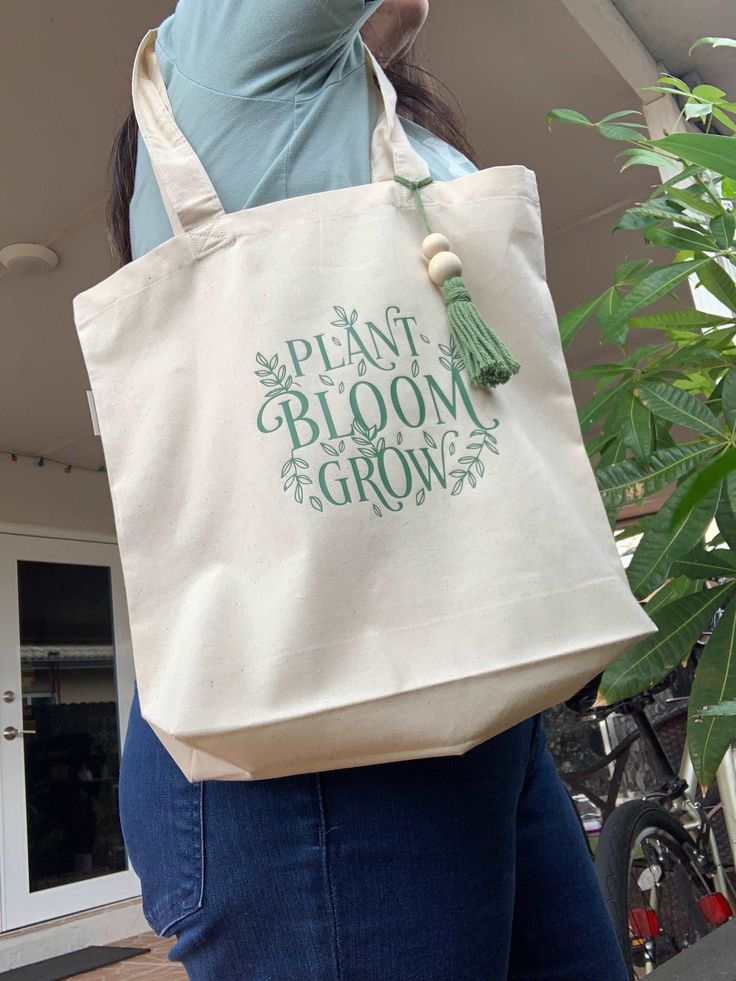 This beautiful plant bloom grow shopping tote bag made with 100% organic cotton, has intentionally handles reinforced. You can use this bag also for a visit to the library, day at the beach or a day of grocery shopping. Surprise a friends, maid of honor, bridesmaid, mother or any family loved one with this aesthetic organic tote bag! Tote Canva Bag Durable 6-ounce, 100% certified organic cotton tote bags Chemical Free Organic cotton handles reinforced with stress-point stitching Expandable botto Library Day, Grow Shop, Iron Design, Shopping Tote Bag, Chemical Free, Grocery Shopping, The Library, Shopping Tote, Family Love