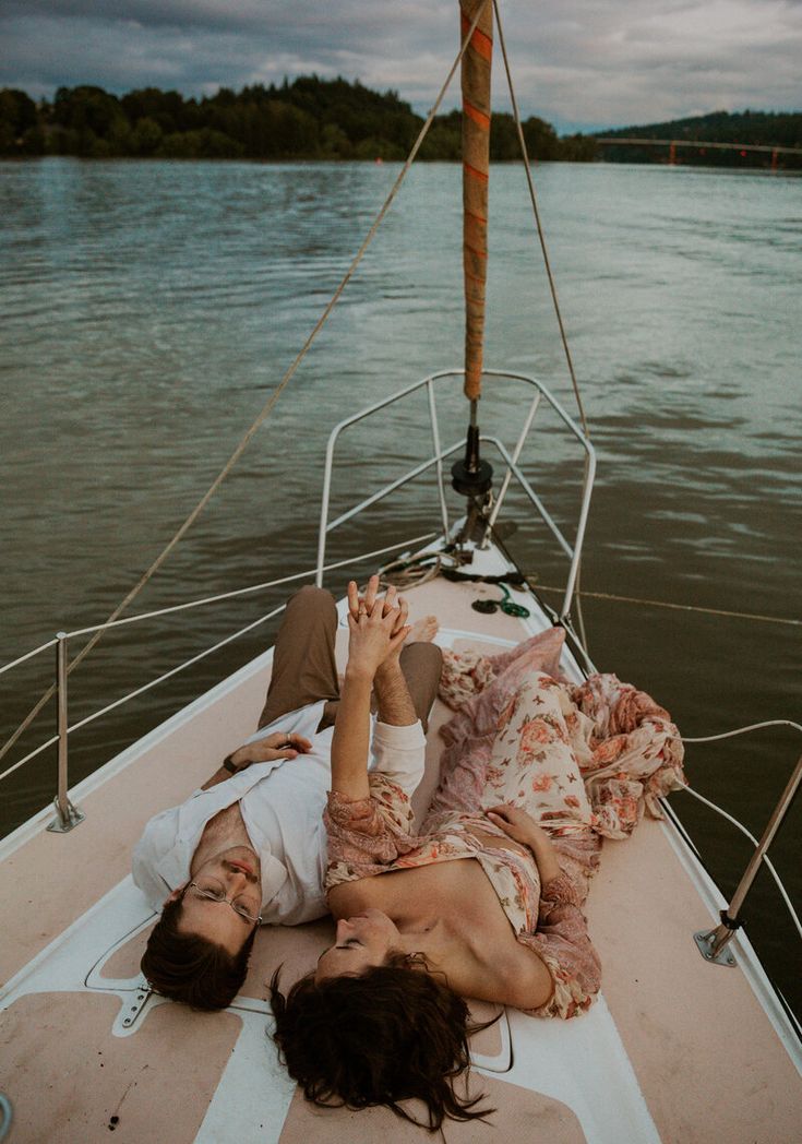 a woman laying on the back of a boat