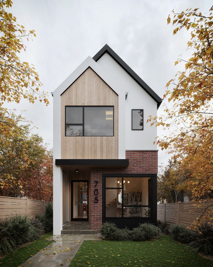 a modern house with black and white trim on the front, windows, and doors