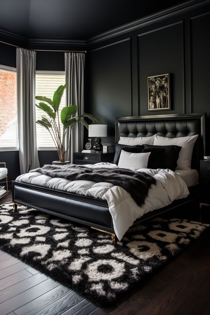 a black and white bedroom with a large bed