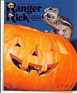 an animal is sitting on top of a jack - o'- lantern with its mouth open