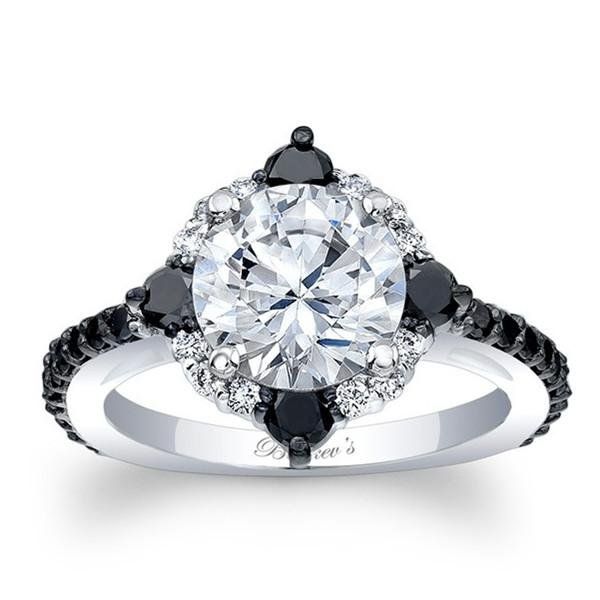 an engagement ring with black and white diamonds