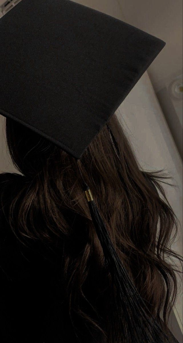 a woman wearing a black graduation cap with a tassel on it's head