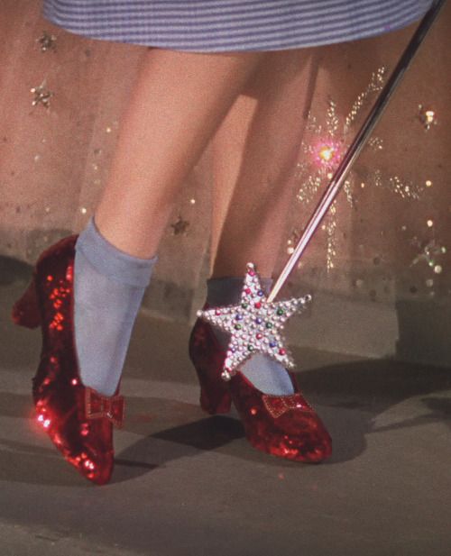 a close up of a person's red shoes with a star decoration on them