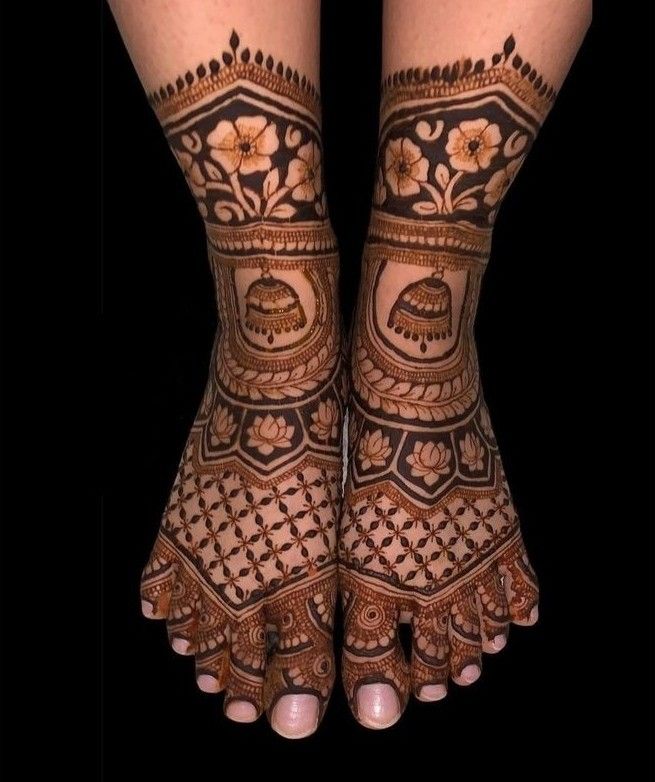 the legs and feet of a woman with henna tattoos