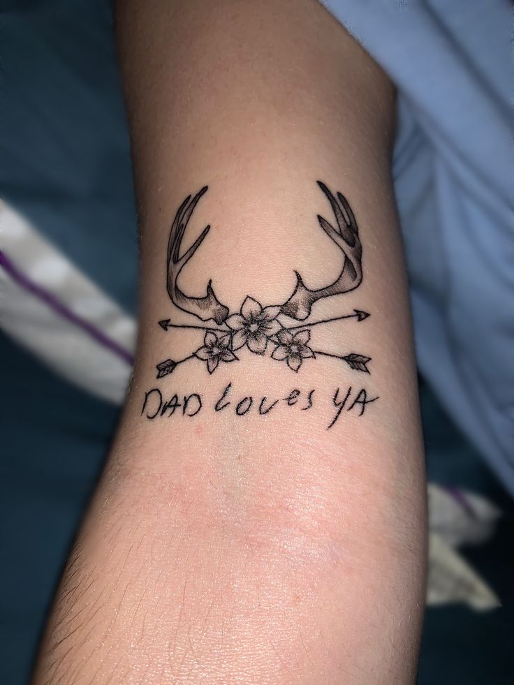 a tattoo that says dad loves ya with antlers and flowers