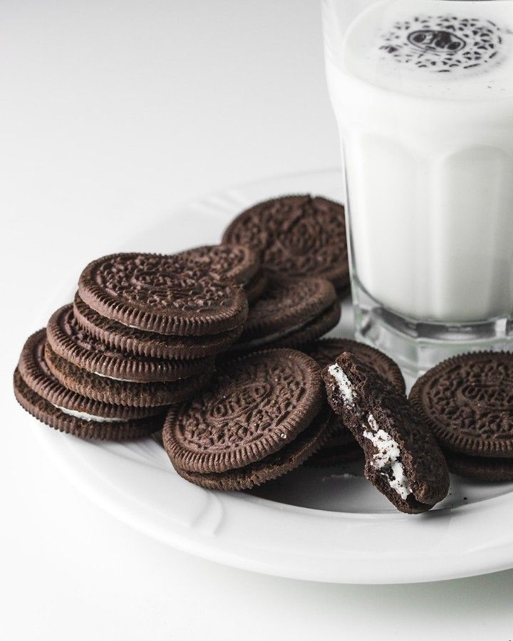 cookies and milk are on a plate next to a glass of milk