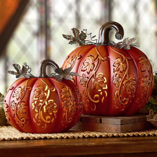 two decorative pumpkins sitting on top of a table