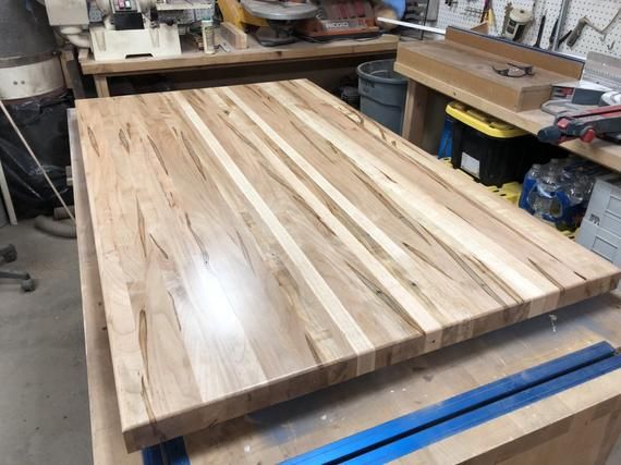 a workbench in a shop with lots of tools on the table and wood planks