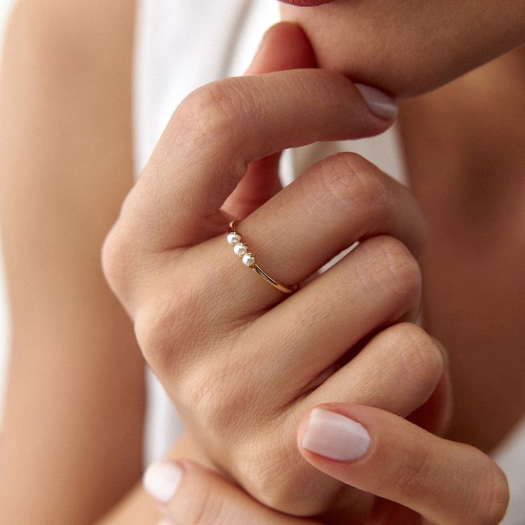 Our lovely minimal 14k solid gold pearl ring. Simple and elegant. 14K solid gold is perfect for everyday wear since it will never tarnish, and you don't have to worry about contact with conditioners or water. A perfect ring to stack as well. ★ Ring Features• Gold Kt: 14K Solid Gold (All rings are stamped for authenticity)• Available Gold Color: Yellow Gold• Man made pearls• Band Width: 1.4 mm Elegant 14k Gold Filled Stackable Promise Rings, Elegant Stackable 14k Gold-filled Promise Rings, Elegant Stackable 14k Gold Filled Rings, Elegant 14k Gold-filled Promise Ring, Elegant 14k Gold-filled Midi Rings, Elegant Tiny Rings For Everyday Wear, Elegant 14k Gold Filled Midi Rings With Round Band, Elegant 14k Gold Filled Open Midi Rings, Elegant Tiny Rings For Everyday