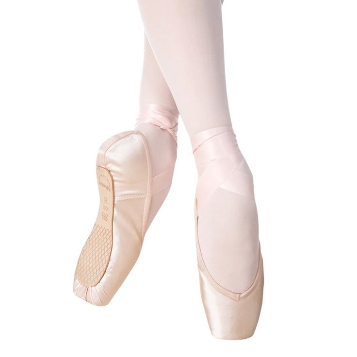 the feet of a ballerina in pink ballet shoes