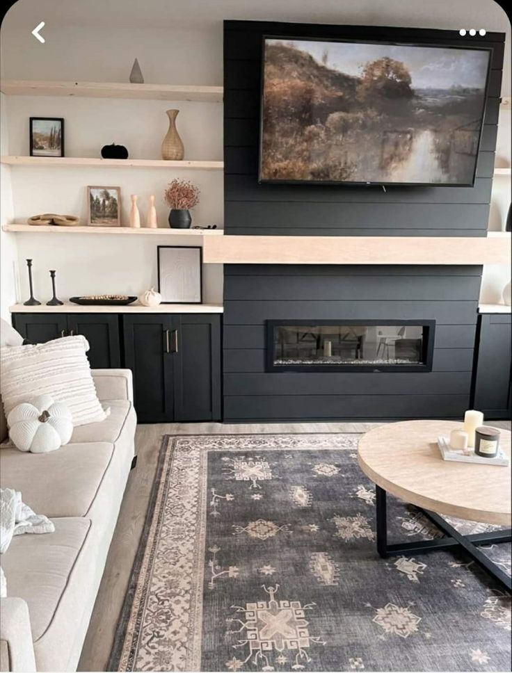 a living room filled with furniture and a flat screen tv mounted on the wall above a fireplace