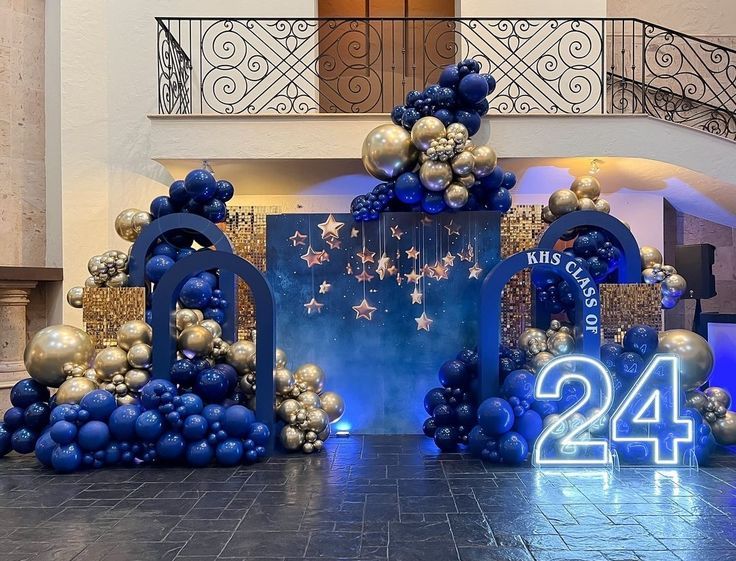 an entrance decorated with blue and gold balloons