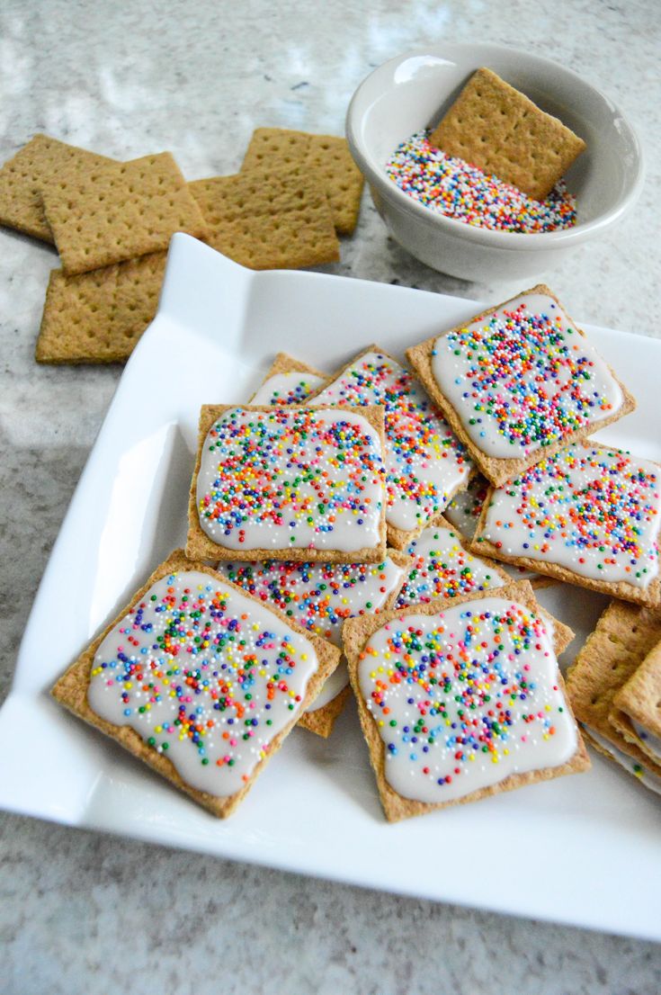 a white plate topped with crackers and sprinkles