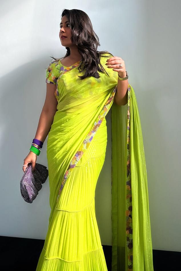 Lime green pre-draped saree with floral embroidered border and cording detail. Paired with embroidered blouse.
Component: 2
Pattern: Embroidery
Type Of Work: Floral, Cording
Neckline: Leaf
Sleeve Type: Short
Fabric: Lurex, Nokia Silk
Color: Green
Other Details: 
Cording detail
Note: The suit worn by the other model on the left is not for sale
Occasion: Mehendi and Haldi - Aza Fashions Green Floor-length Pre-draped Saree With Resham Embroidery, Green Pre-draped Saree With Resham Embroidery In Georgette, Green Semi-stitched Georgette Pre-draped Saree, Green Floor-length Saree With Resham Embroidery, Green Resham Embroidery Floor-length Saree, Green Floor-length Pre-draped Saree With Dupatta, Designer Green Semi-stitched Pre-draped Saree, Designer Wear Pista Green Georgette Pre-draped Saree, Green Cutdana Pre-draped Saree Floor-length