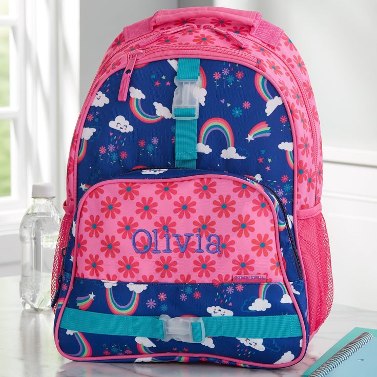 "Make a big and sassy entrance at school with our Rainbow Print Personalized Backpack by Stephen Joseph. Our super comfortable kids backpack is designed to securely hold anything you need! - Embroidered with any name in your choice of font and thread color - Each item sold separately - Features cushioned adjustable shoulder straps with a top carrying handle - Includes two mesh exterior side pockets and two outside hook-on straps - Three interior storage compartments; main compartment includes an Street Backpack, Personalized Backpack Kids, Personalization Mall, Embroidered Backpack, Personalized Memorial Gifts, Custom Backpack, Rolling Backpack, Pink Color Schemes, Personalized Backpack