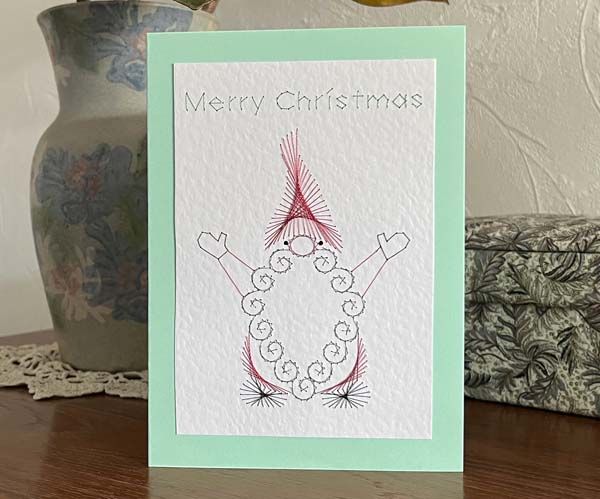 a card with a drawing of a snowman on it