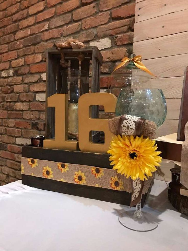 the table is decorated with sunflowers and an old fashioned number thirteen candle holder