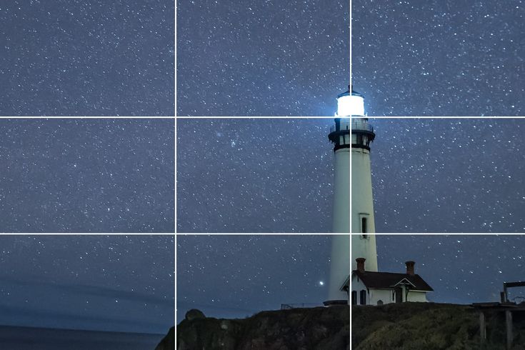 the lighthouse is lit up at night with stars in the sky above it and below