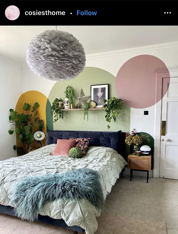 a bedroom decorated in shades of green, pink and yellow with plants on the wall