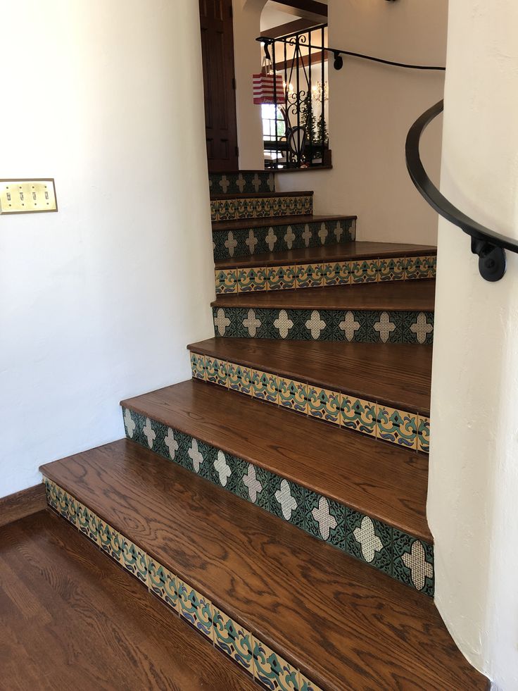 a set of stairs with tile and wood treads