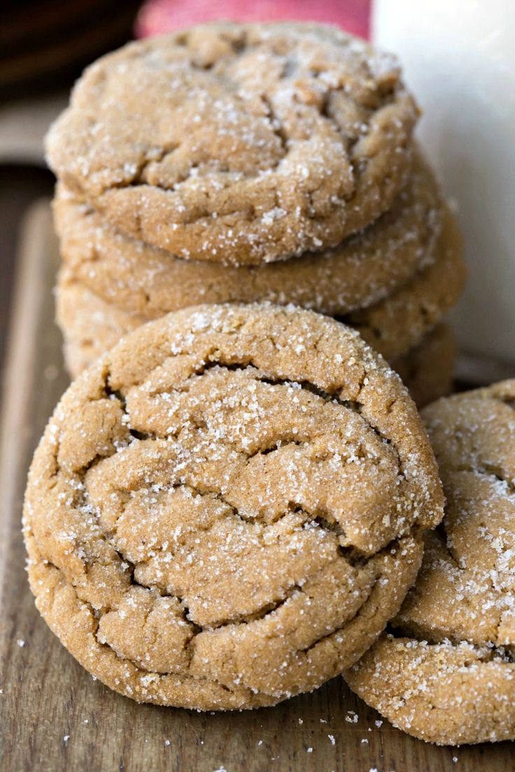 three cookies are stacked on top of each other with powdered sugar in the middle