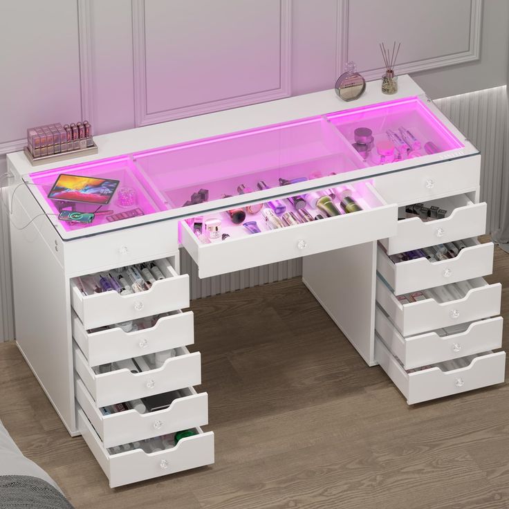 a white desk with drawers and pink lights