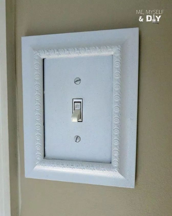 a white light switch sitting on top of a wall