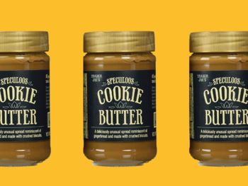 three jars of cookie butter on a yellow background