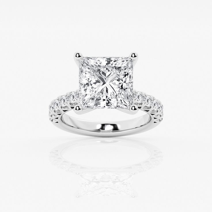 a princess cut diamond engagement ring on a white background