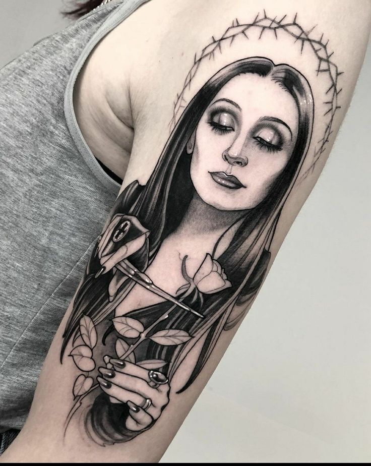 a woman's arm with a tattoo on it and a glass in her hand